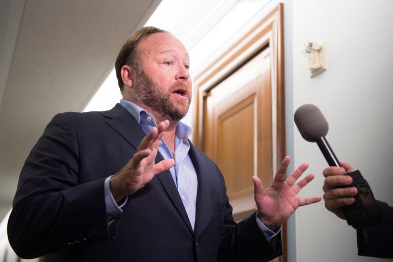 Right-wing conspiracy theorist Alex Jones speaks with reporters outside the Senate Intelligence Committee.